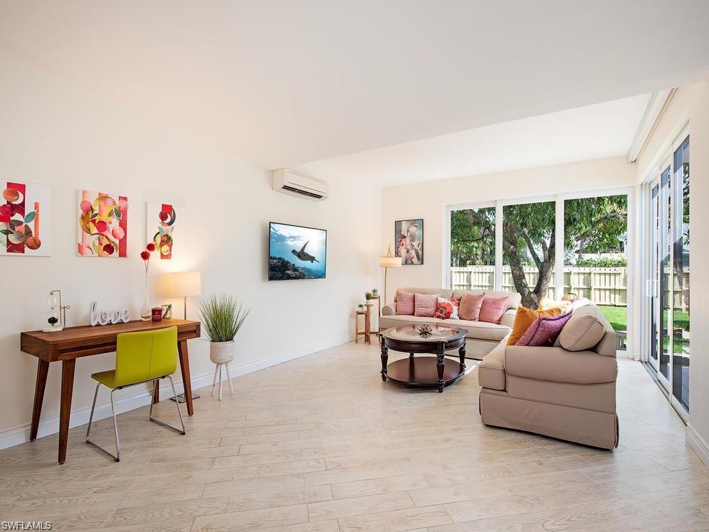 757 Broad Court South Naples, FL 34102 - Photo 2 of 12 a living room with furniture and a large window