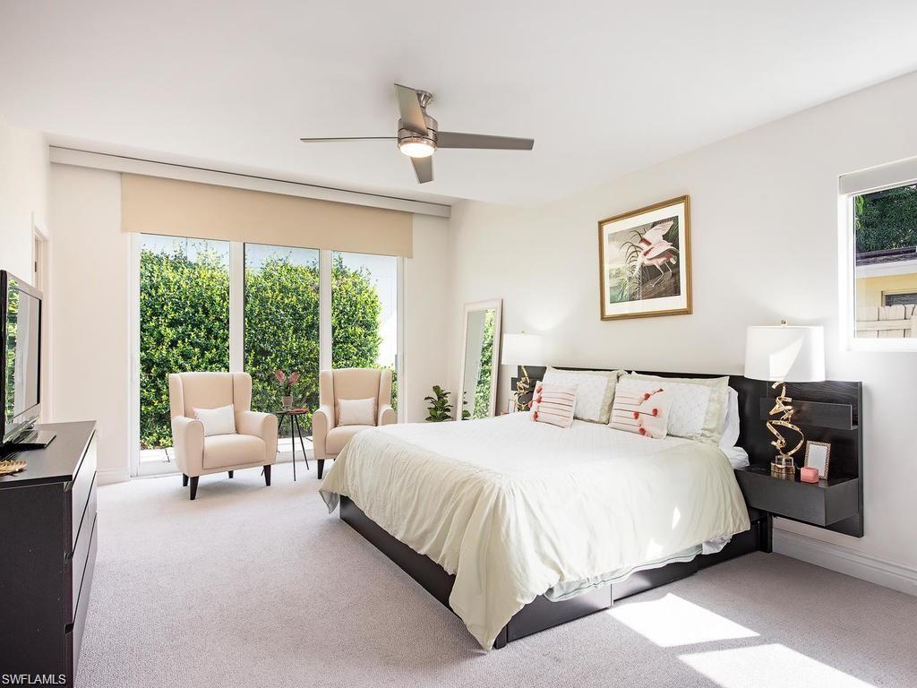 757 Broad Court South Naples, FL 34102 - Photo 5 of 12 a bedroom with a bed and a large window