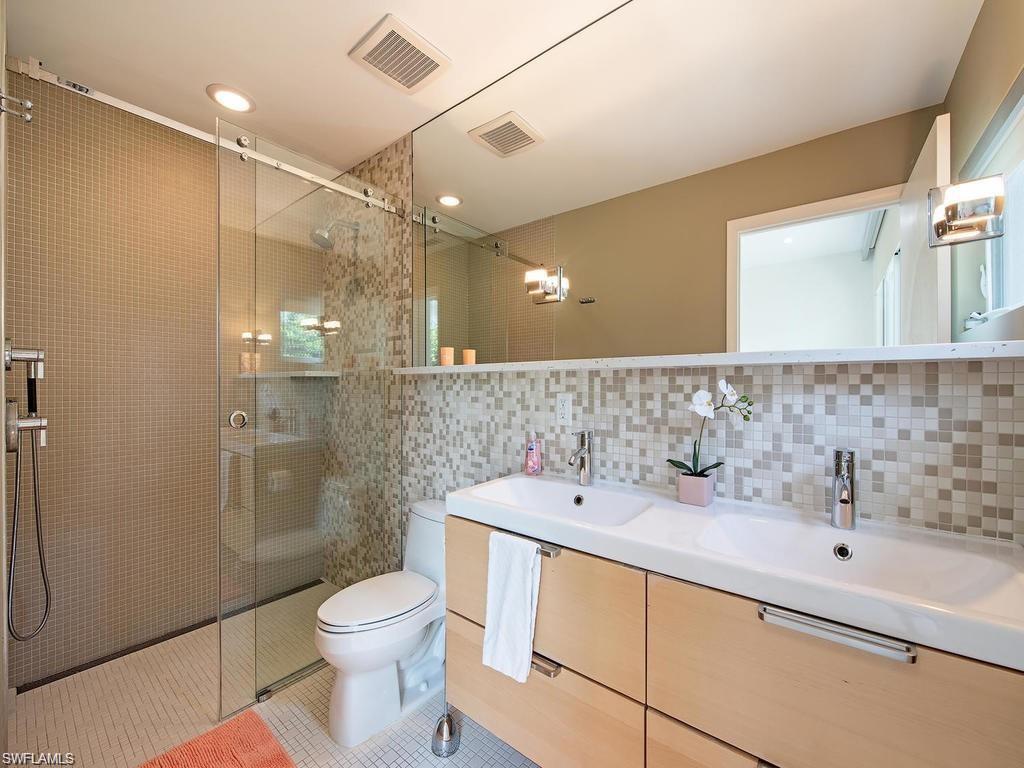 757 Broad Court South Naples, FL 34102 - Photo 6 of 12 a bathroom with a sink a toilet and shower