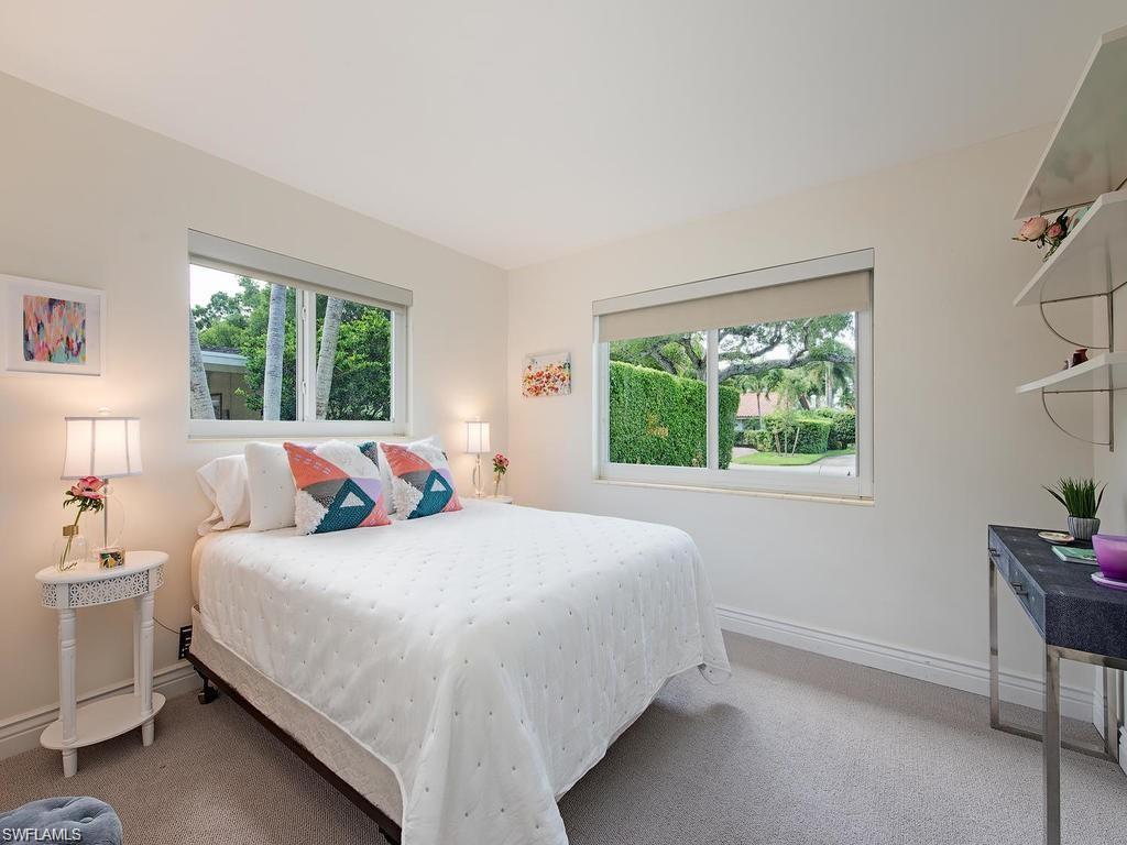 757 Broad Court South Naples, FL 34102 - Photo 7 of 12 a bedroom with a bed and a window