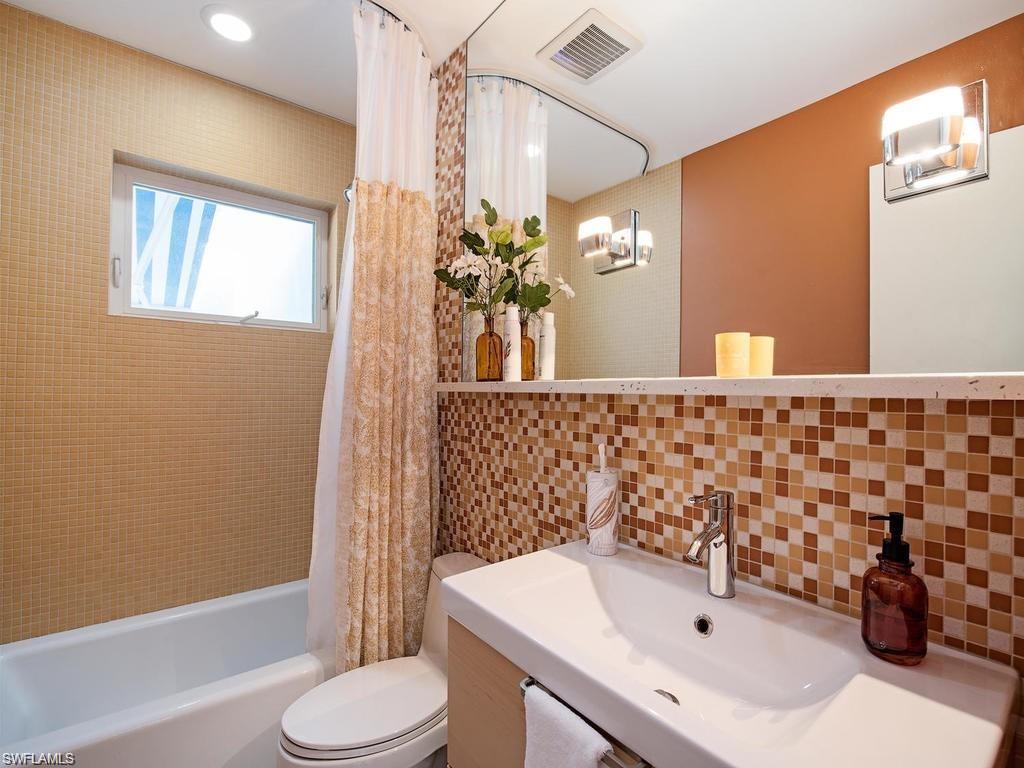 757 Broad Court South Naples, FL 34102 - Photo 8 of 12 a bathroom with a sink toilet and shower