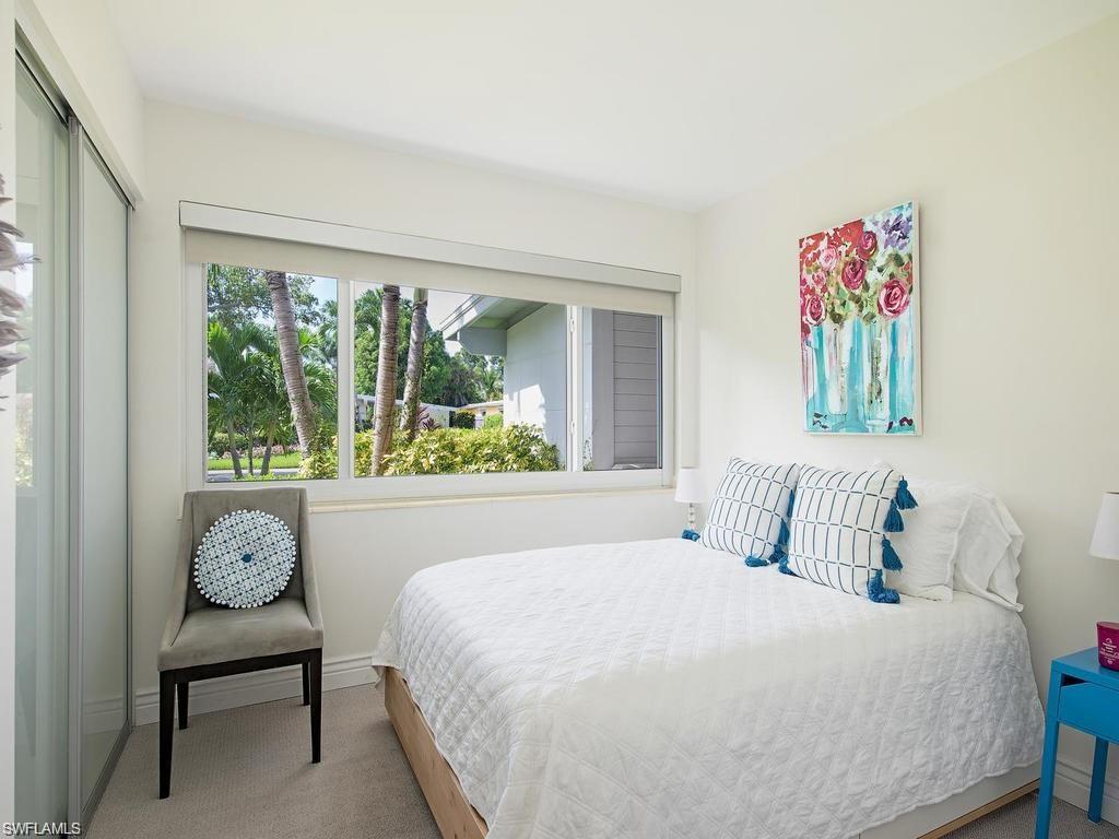 757 Broad Court South Naples, FL 34102 - Photo 9 of 12 a bedroom with a bed and a painting on the wall