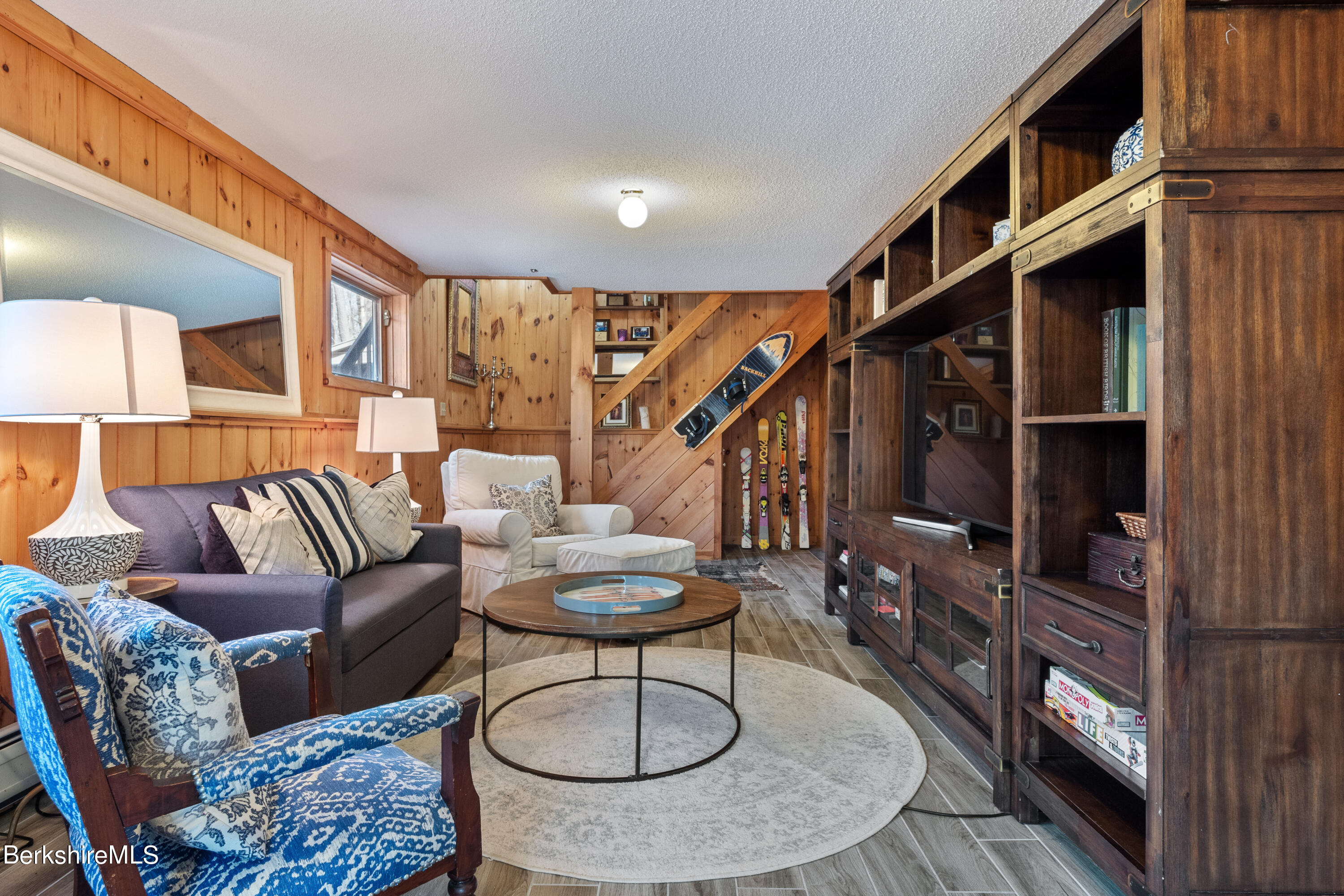 201 Judd Road Otis, MA 01253 - Photo 33 of 38 a living room with furniture a rug and a painting on the wall