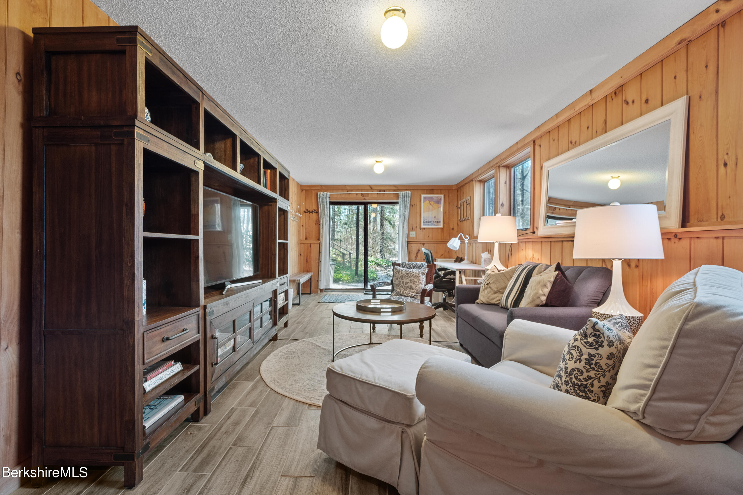 201 Judd Road Otis, MA 01253 - Photo 34 of 38 a living room with furniture a flat screen tv and large window