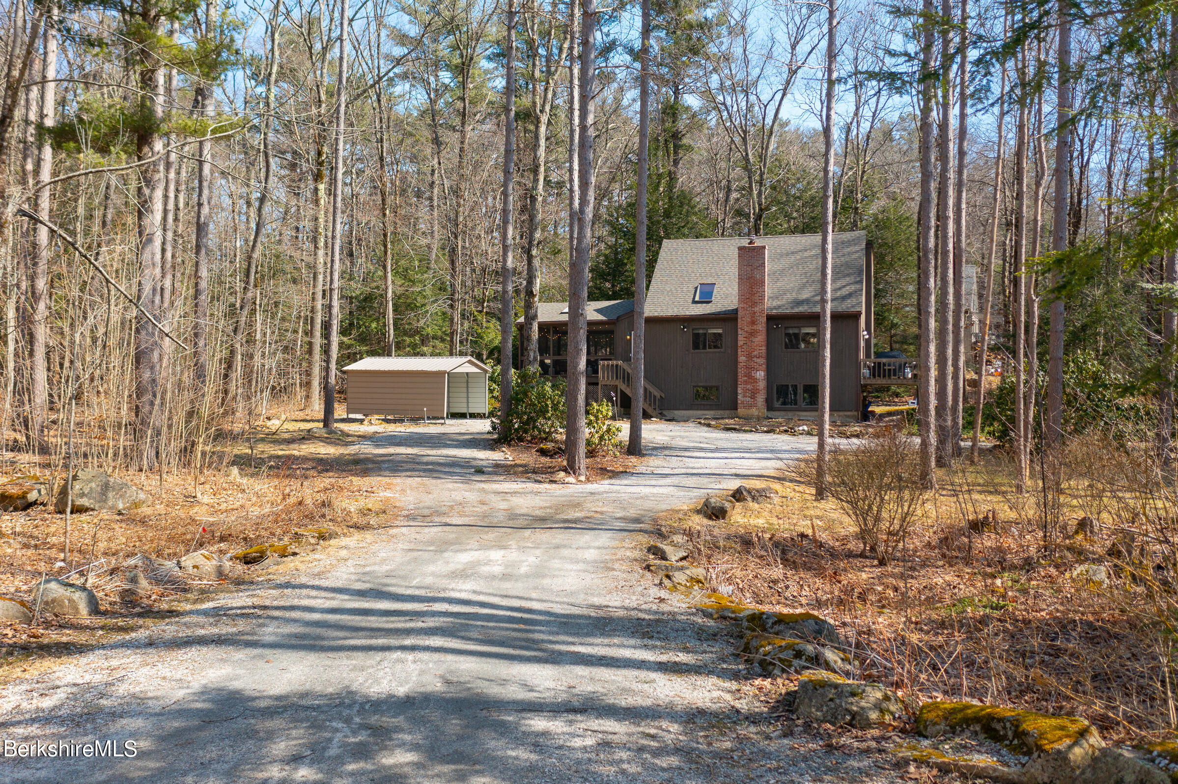 201 Judd Road Otis, MA 01253 - Photo 5 of 38 a front view of a house with a garden