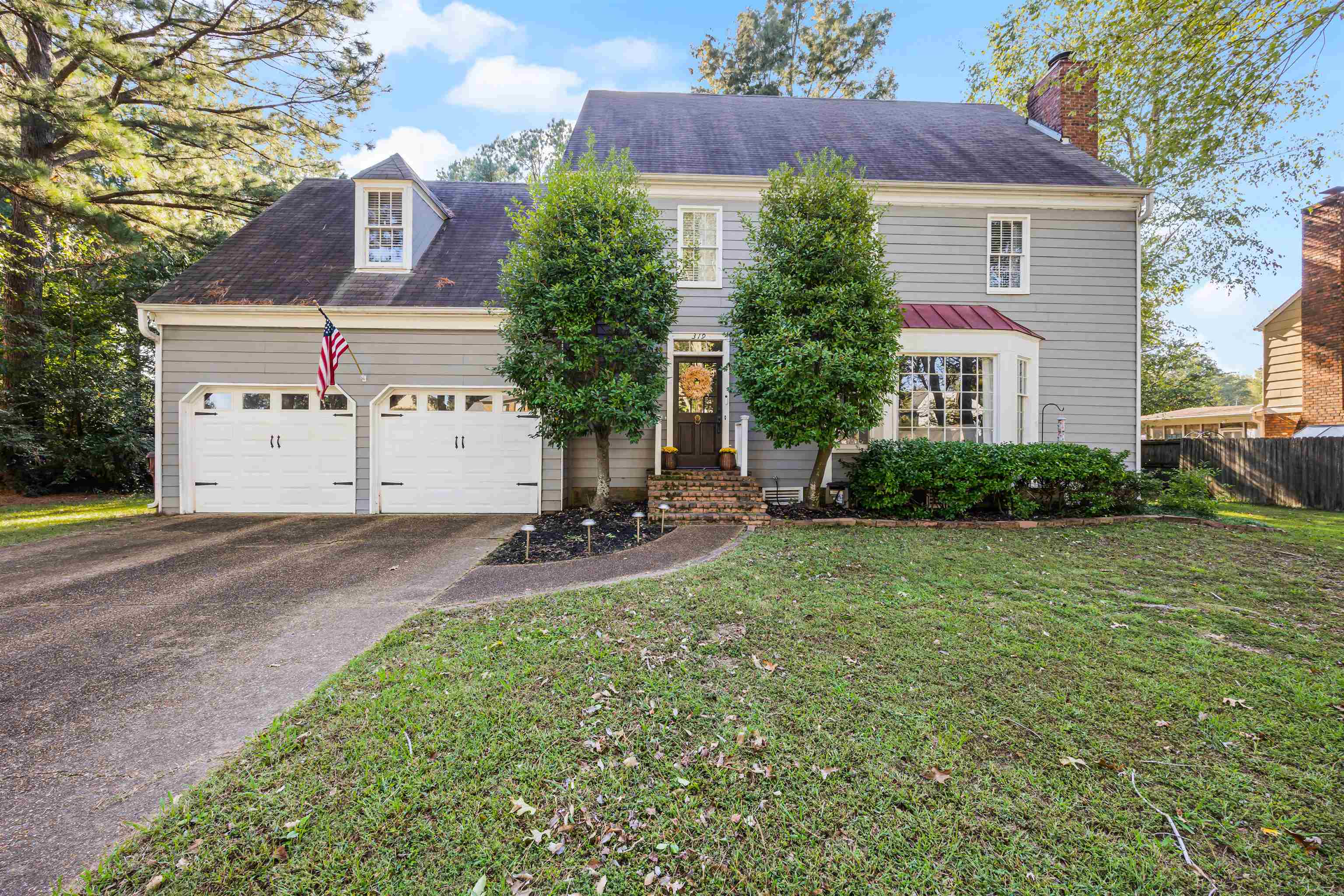 319 East Harpers Ferry Road Collierville, TN 38017 - Photo 1 of 27 View of front of property featuring a garage and a front lawn