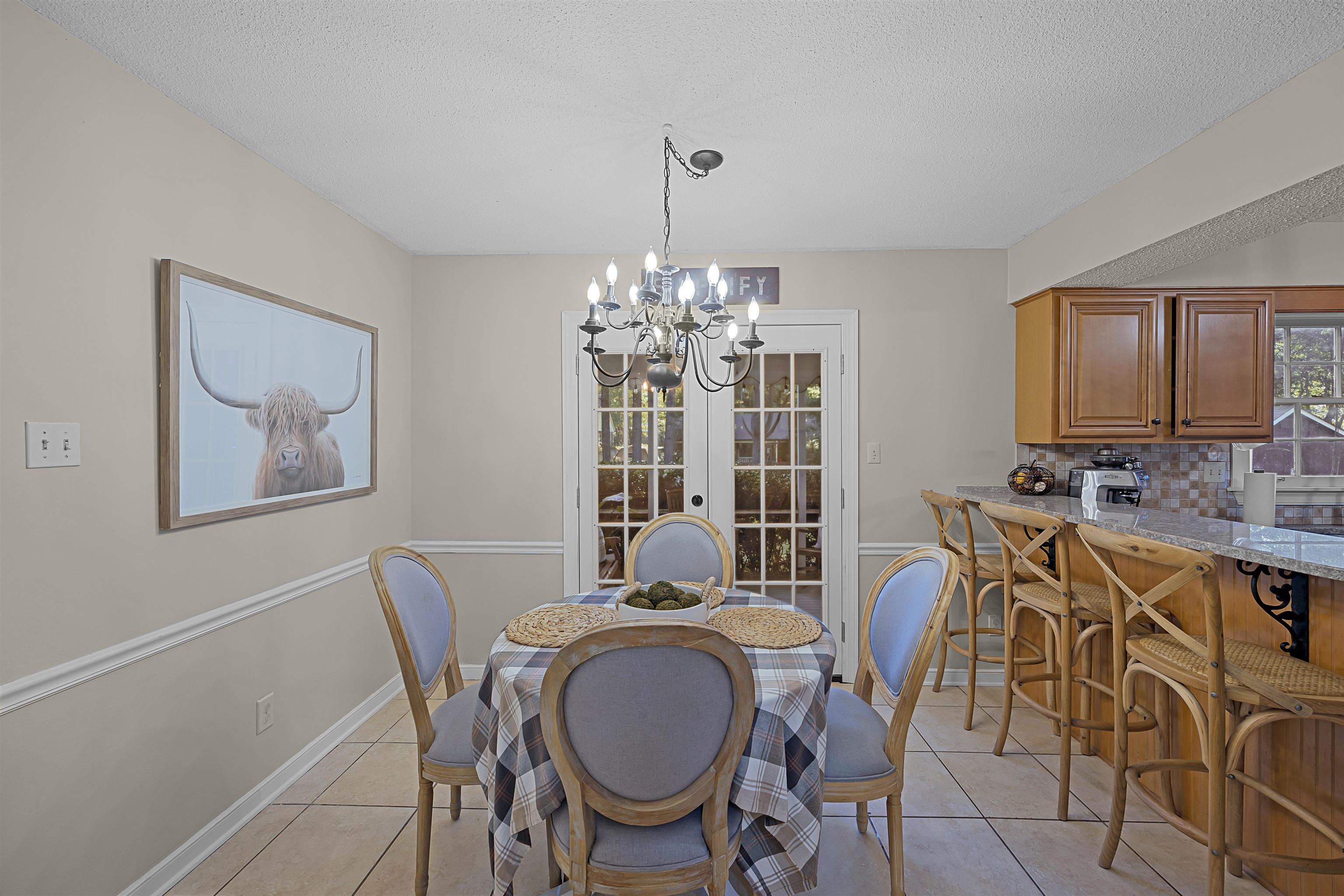 319 East Harpers Ferry Road Collierville, TN 38017 - Photo 11 of 27 Dining room featuring a notable chandelier, light tile patterned flooring, and a textured ceiling