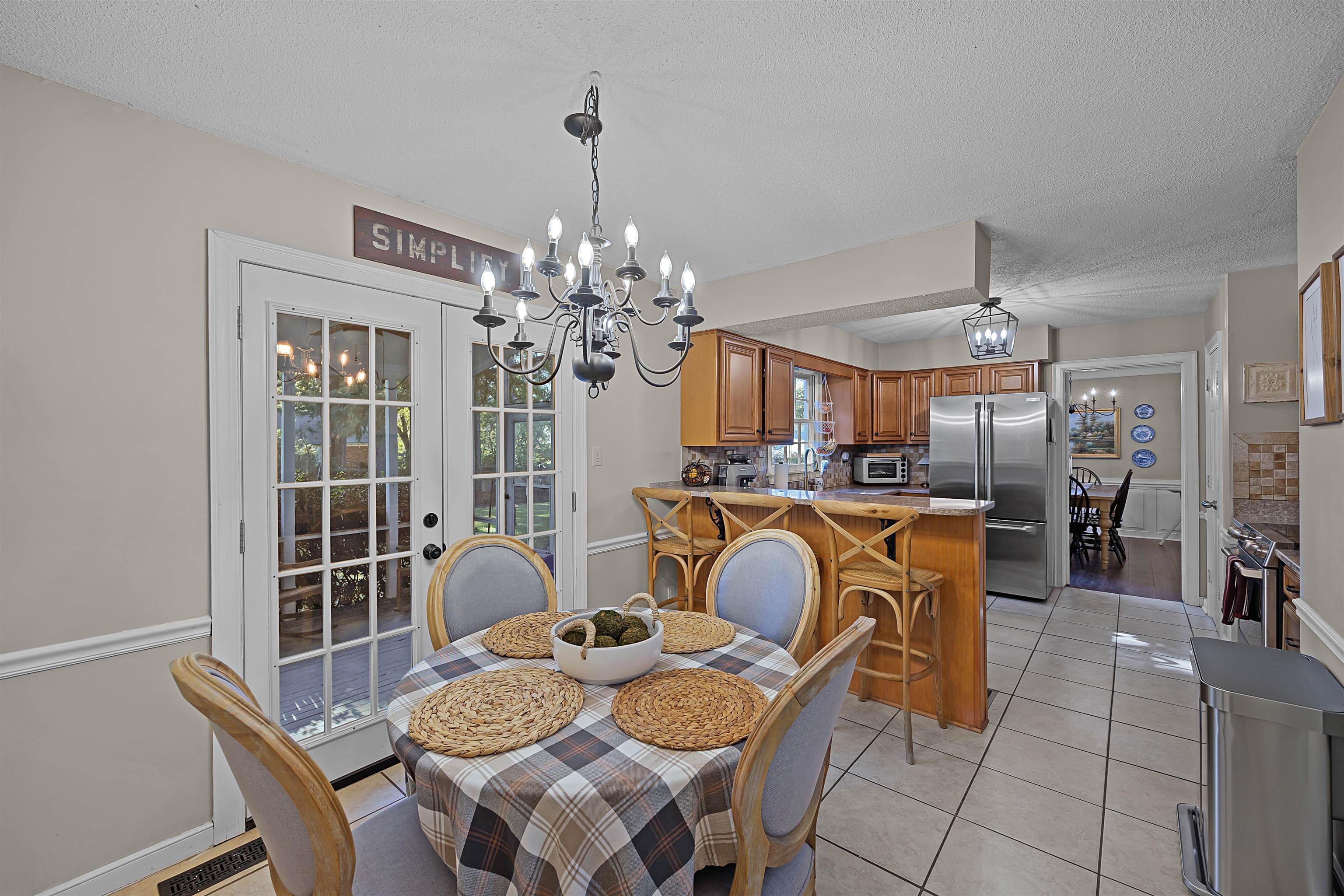 319 East Harpers Ferry Road Collierville, TN 38017 - Photo 12 of 27 Tiled dining room with french doors, a textured ceiling, and a notable chandelier