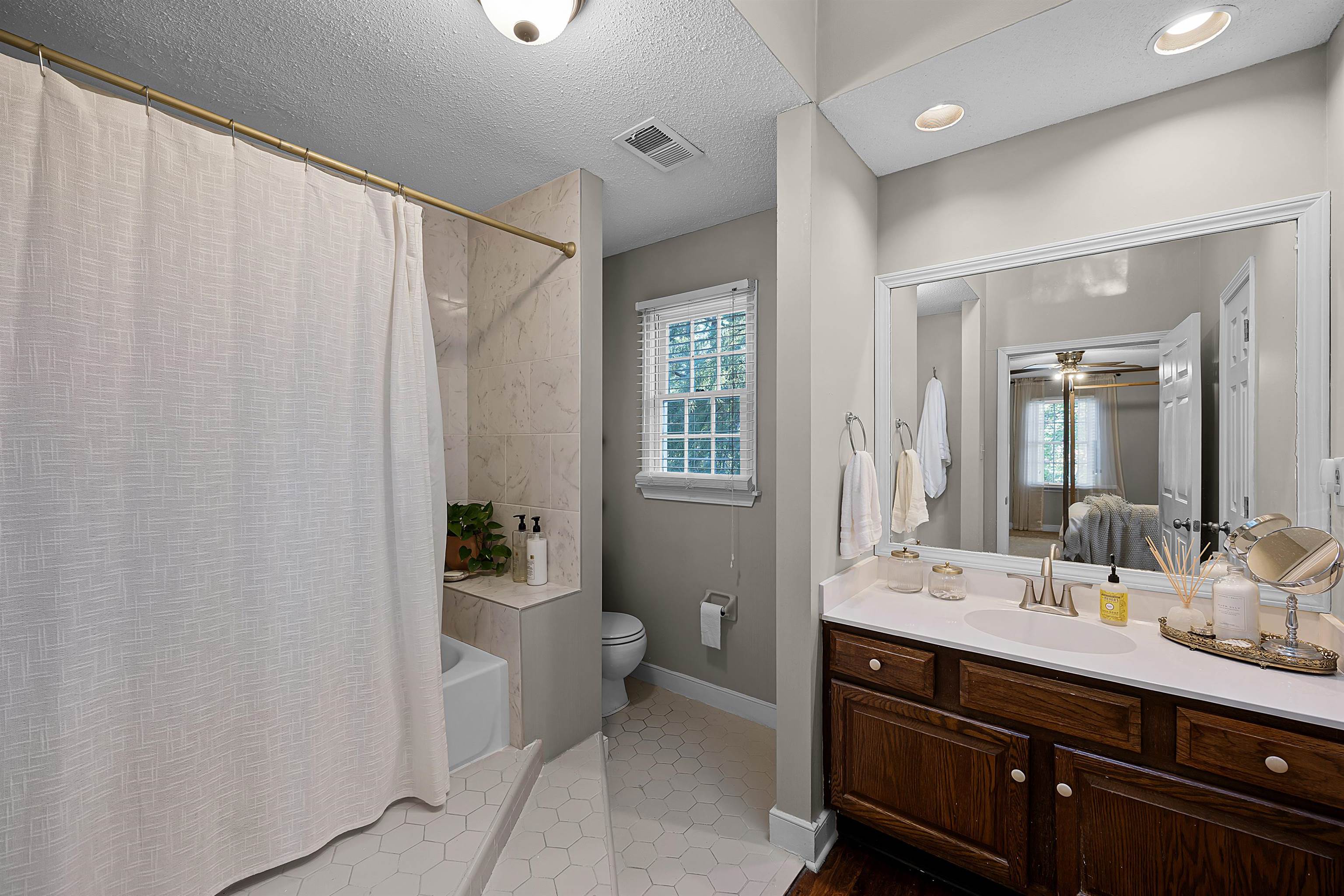 319 East Harpers Ferry Road Collierville, TN 38017 - Photo 16 of 27 Full bathroom with vanity, tile patterned flooring, ceiling fan, toilet, and a textured ceiling