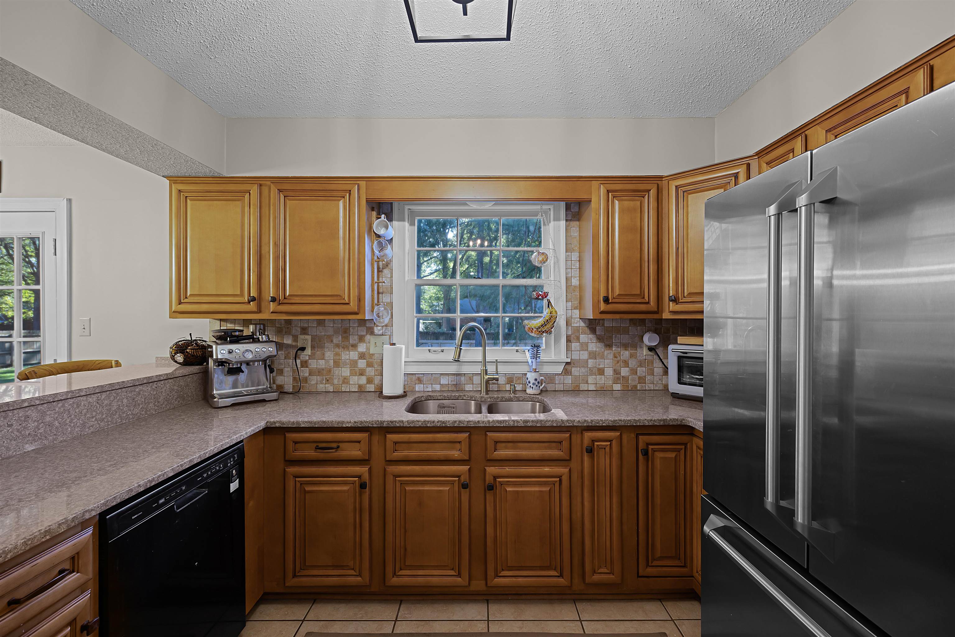 319 East Harpers Ferry Road Collierville, TN 38017 - Photo 9 of 27 Kitchen with sink, black dishwasher, tasteful backsplash, and high end refrigerator