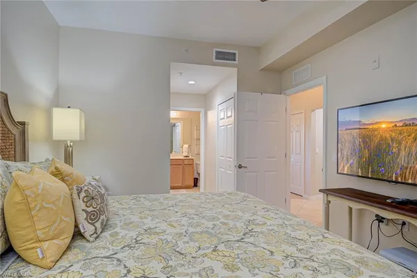 a bedroom with a bed and a flat screen tv