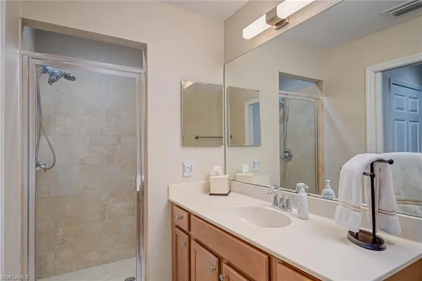 a bathroom with double vanity sink and a mirror