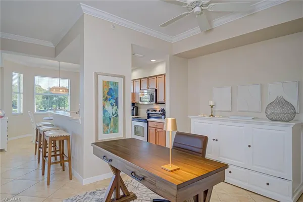 a kitchen with a table chairs and microwave