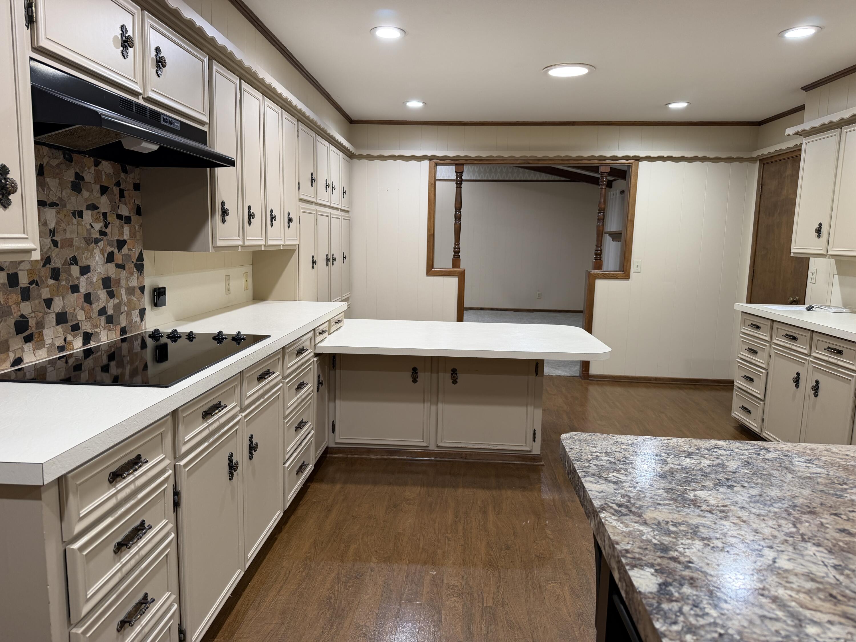 1603 South 8th Street Lamesa, TX 79331 - Photo 8 of 39 a kitchen with stainless steel appliances kitchen island granite countertop a table and a sink