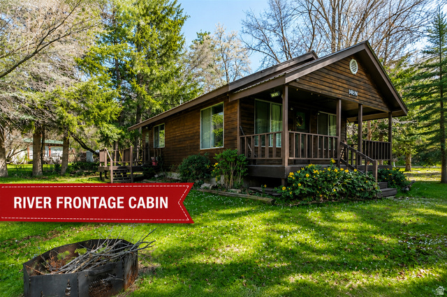 1105 Litz Road Preston, ID 83263 - Photo 1 of 1 Wood-sided cabin featuring a covered front porch with railings and steps