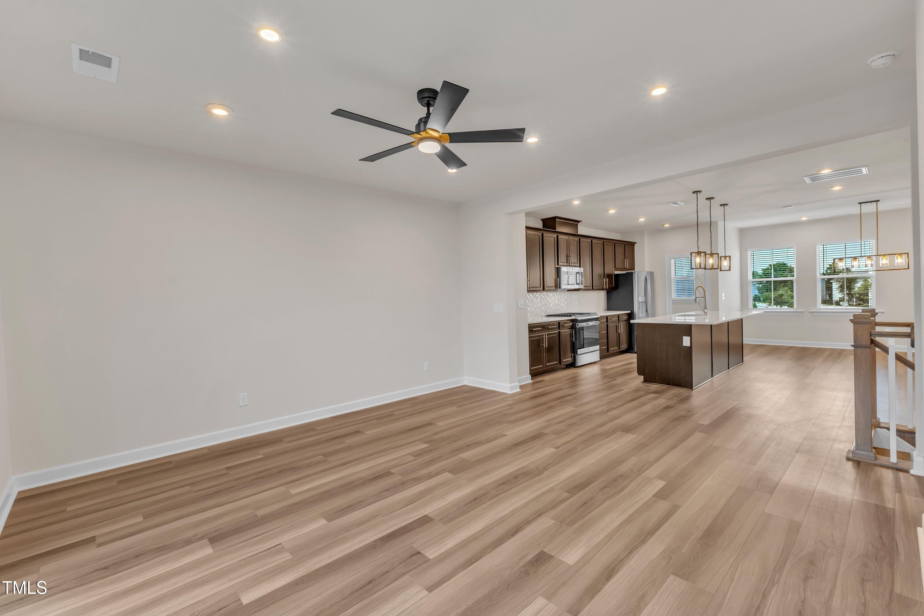 816 Lilyquist Way Wake Forest, NC 27587 - Photo 15 of 53 a view of a kitchen with a sink and a refrigerator