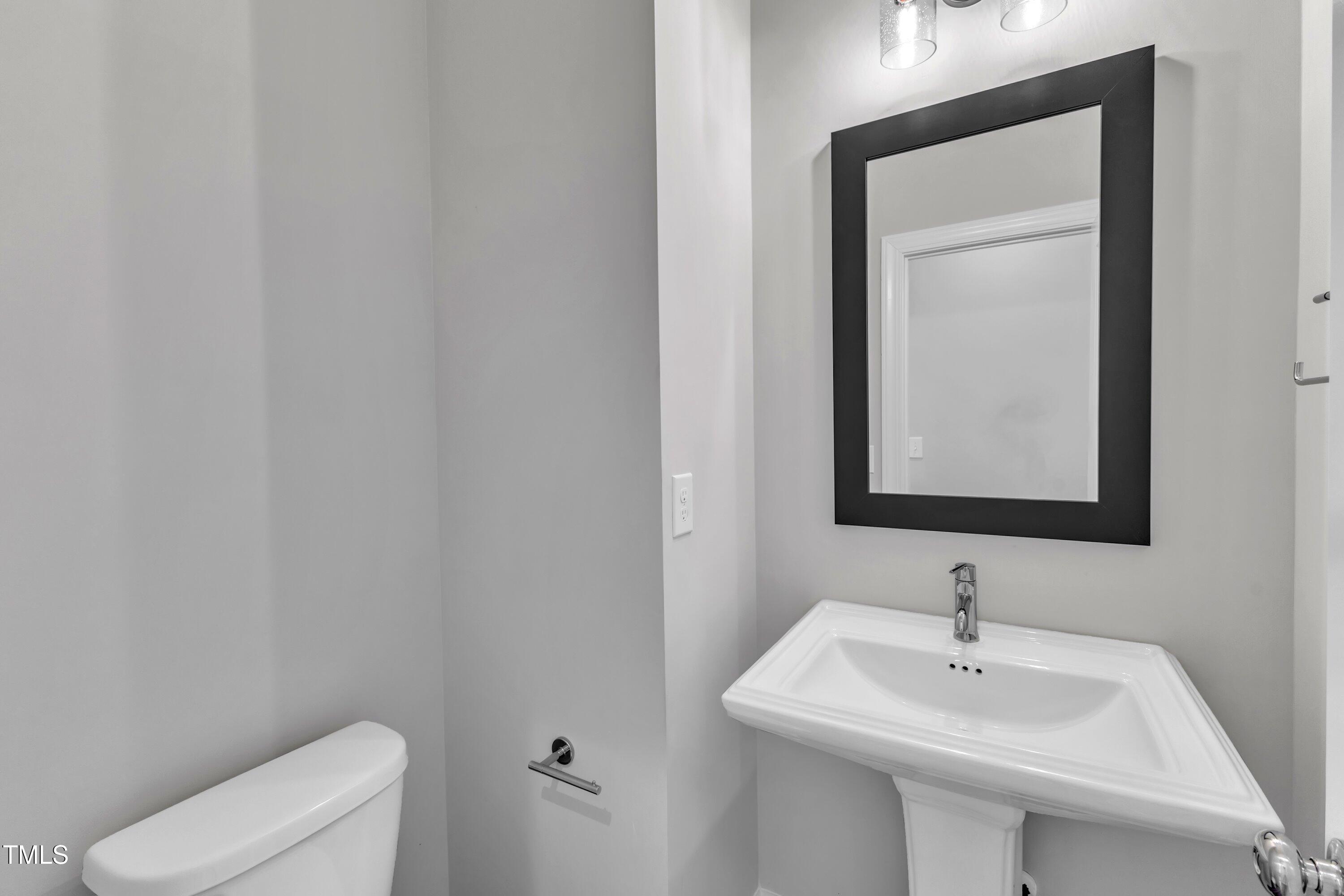 816 Lilyquist Way Wake Forest, NC 27587 - Photo 17 of 53 a bathroom with a toilet sink and mirror