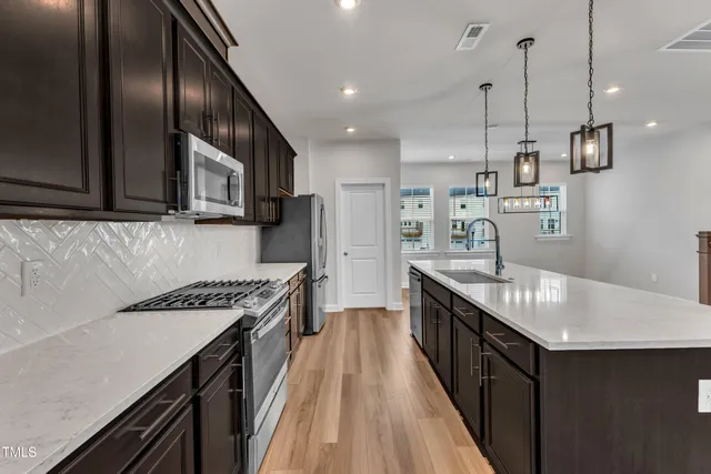 a stove top oven sitting inside of a kitchen