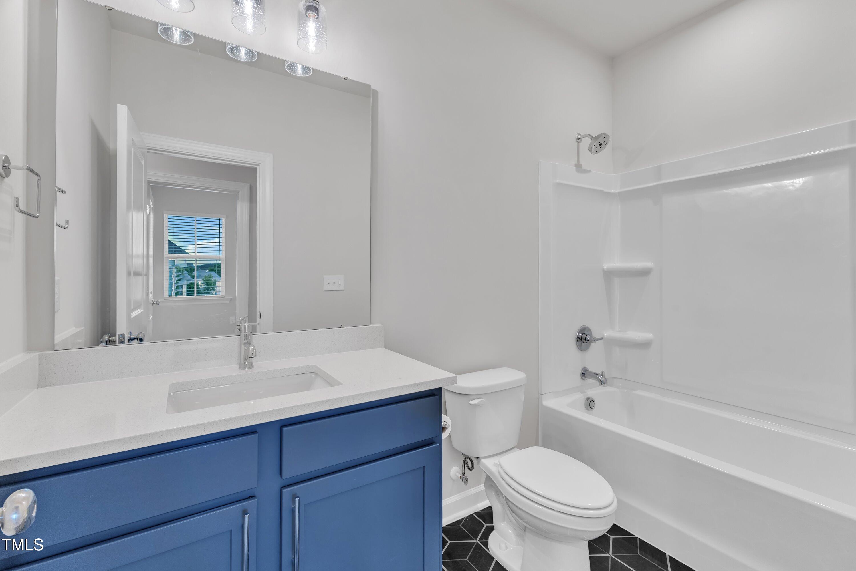 816 Lilyquist Way Wake Forest, NC 27587 - Photo 37 of 53 a bathroom with a sink toilet vanity and shower