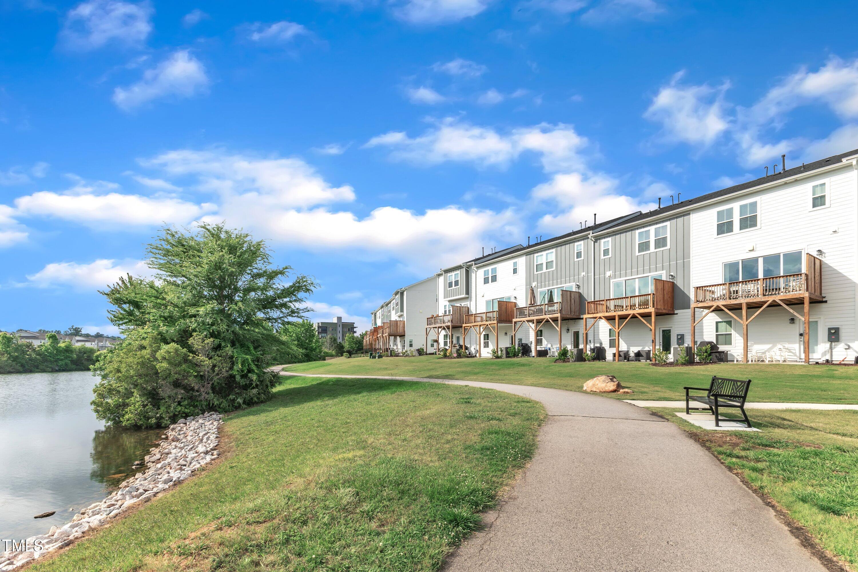 816 Lilyquist Way Wake Forest, NC 27587 - Photo 43 of 53 a front view of building with yard and trees in the background