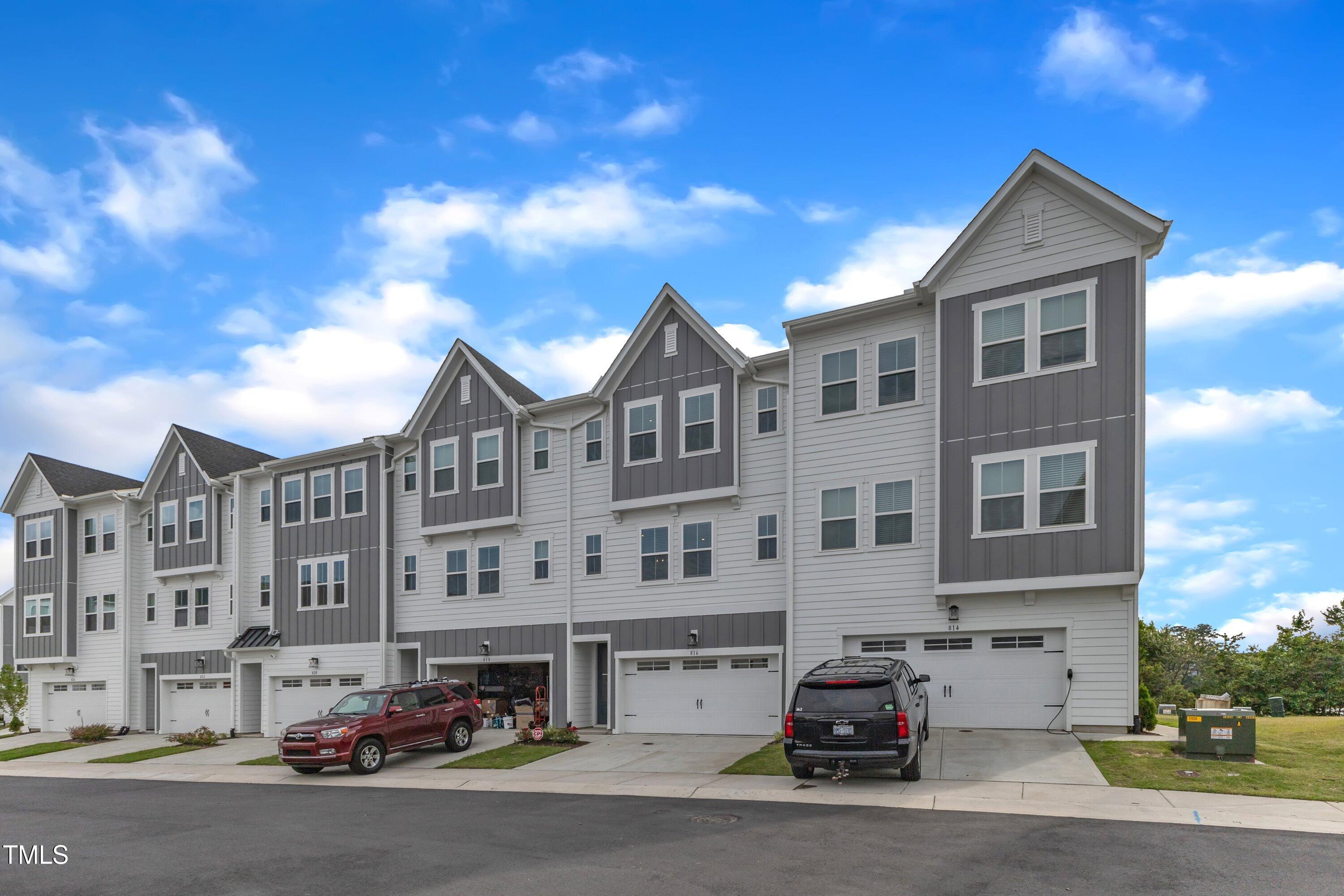 816 Lilyquist Way Wake Forest, NC 27587 - Photo 48 of 53 a front view of a building with lot of cars and trees