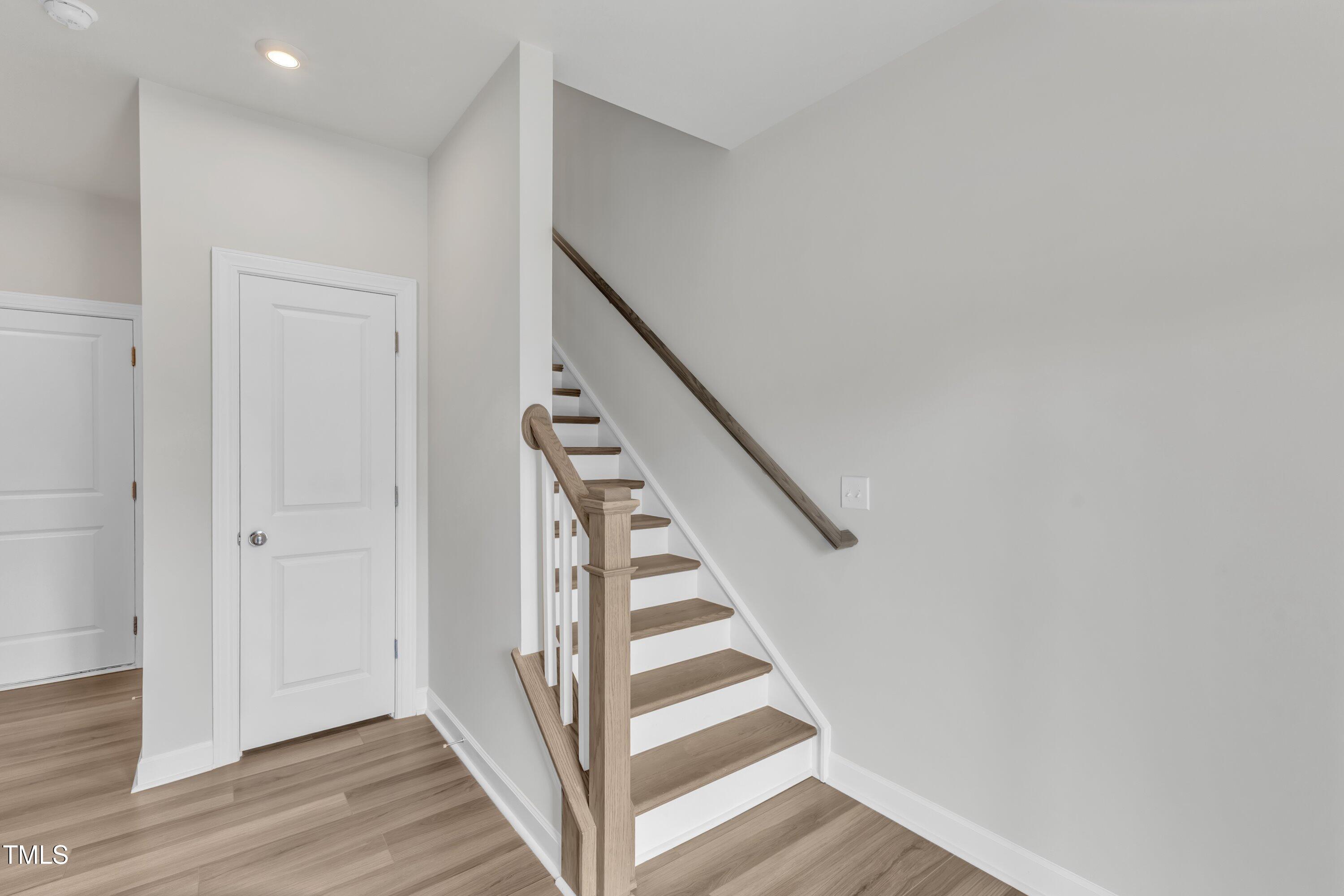 816 Lilyquist Way Wake Forest, NC 27587 - Photo 7 of 53 a view of a hallway with wooden floor and entryway