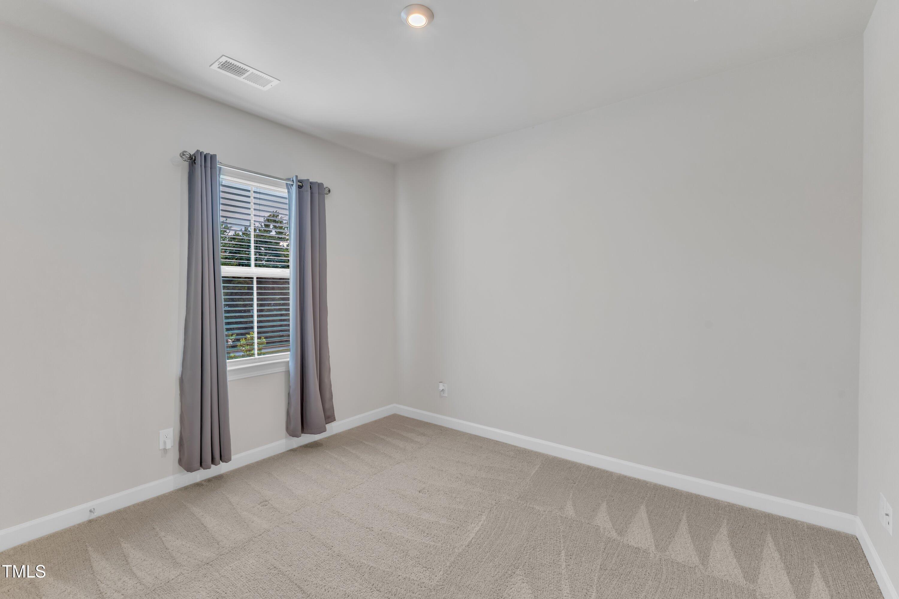 816 Lilyquist Way Wake Forest, NC 27587 - Photo 9 of 53 an empty room with windows