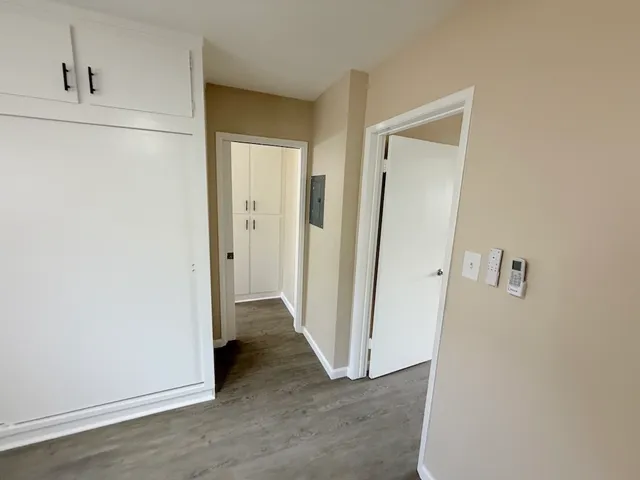 a view of a hallway with wooden floor
