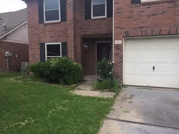 a view of house with backyard and garden