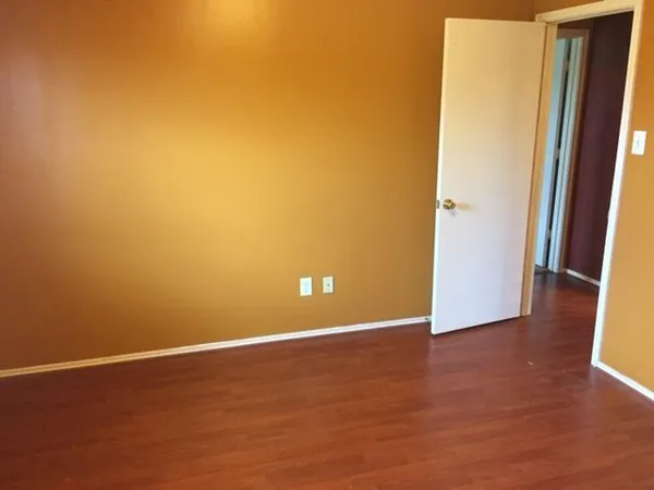 an empty room with wooden floor