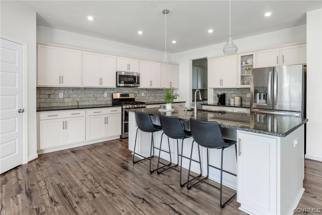 8125 Timberstone Drive Chesterfield, VA 23832 - Photo 13 of 34 a kitchen with stainless steel appliances kitchen island granite countertop a sink and cabinets