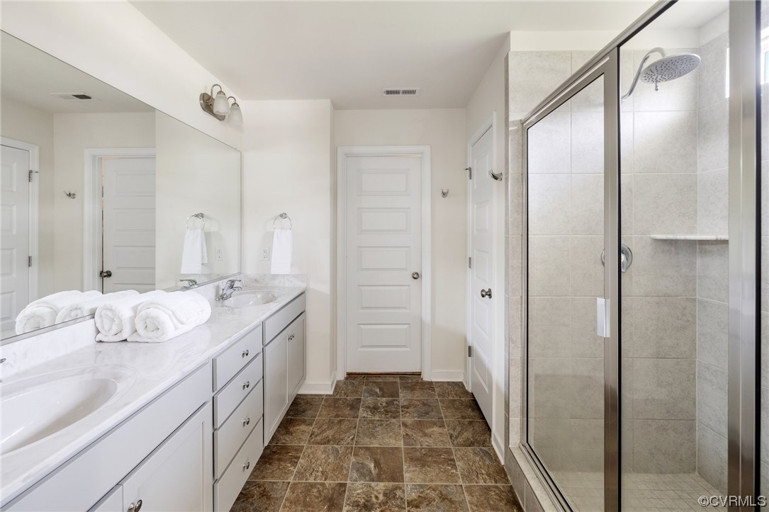 8125 Timberstone Drive Chesterfield, VA 23832 - Photo 31 of 34 a bathroom with a double vanity sink and mirror