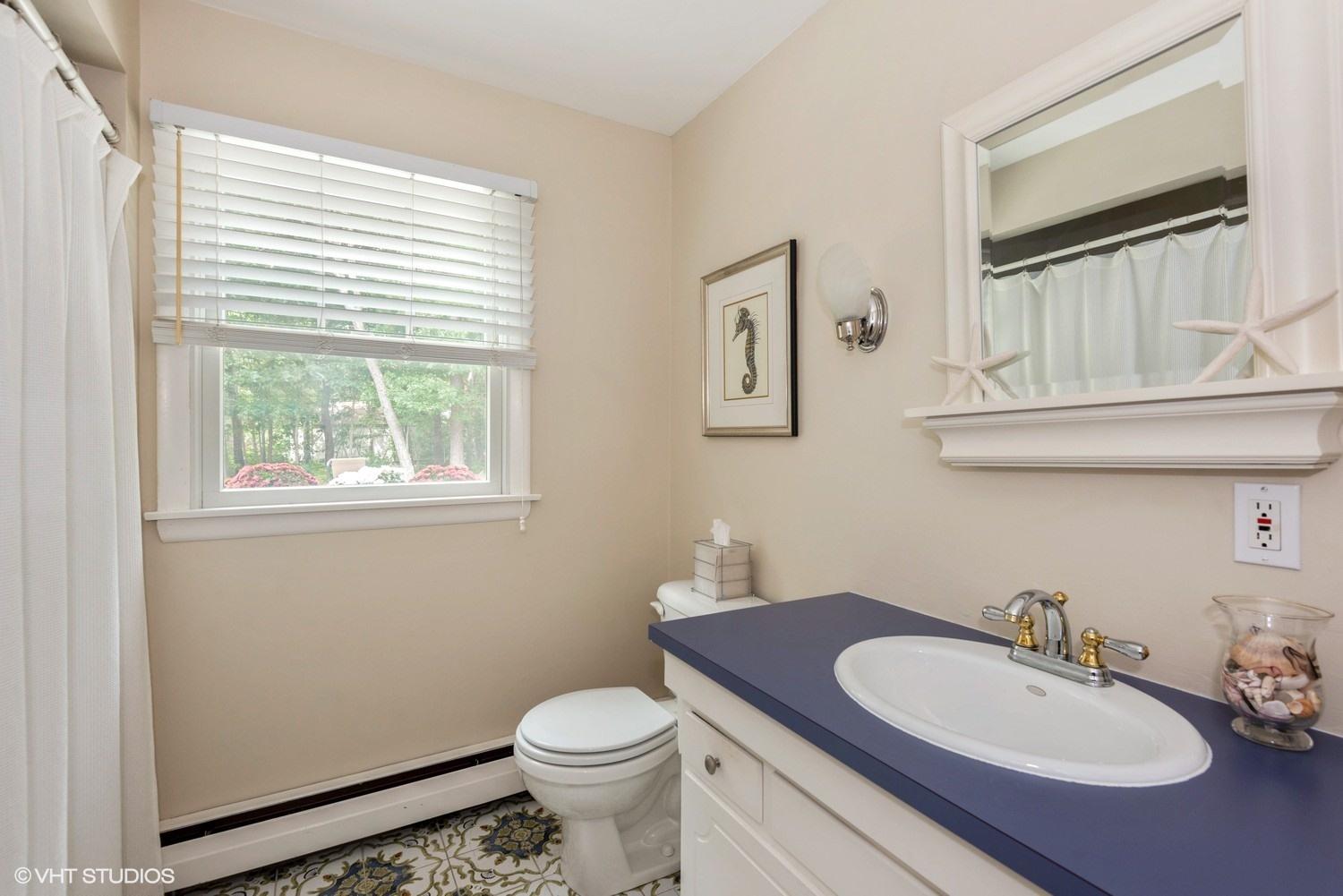 1166 Old Post Road Cotuit, MA 02635 - Photo 13 of 15 a bathroom with a toilet a sink and mirror
