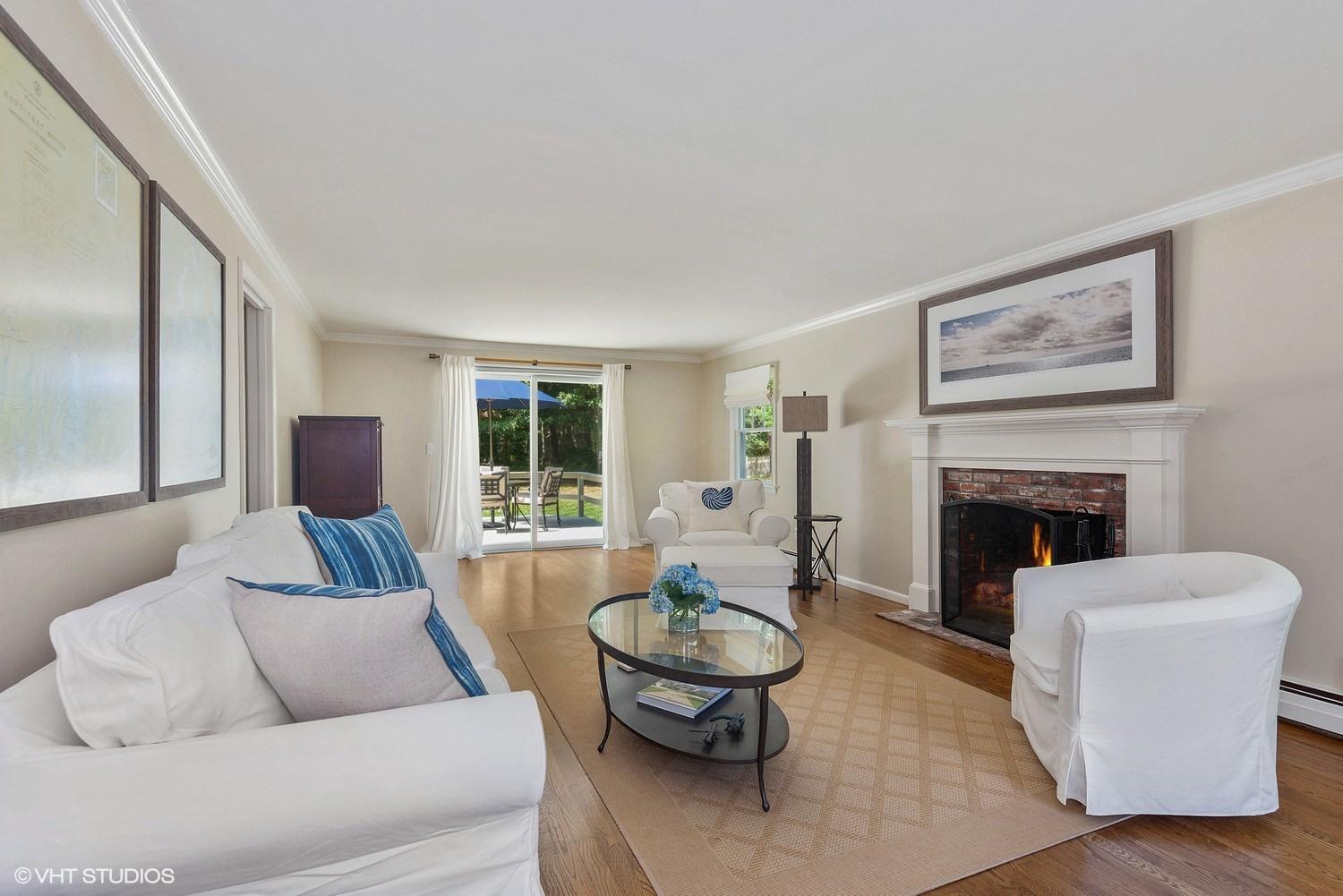 1166 Old Post Road Cotuit, MA 02635 - Photo 5 of 15 a living room with furniture and a fireplace