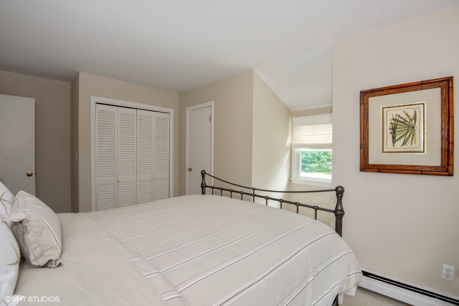 1166 Old Post Road Cotuit, MA 02635 - Photo 10 of 15 a bedroom with a bed and a window