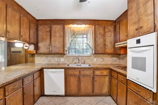 a kitchen with a sink stove and cabinets
