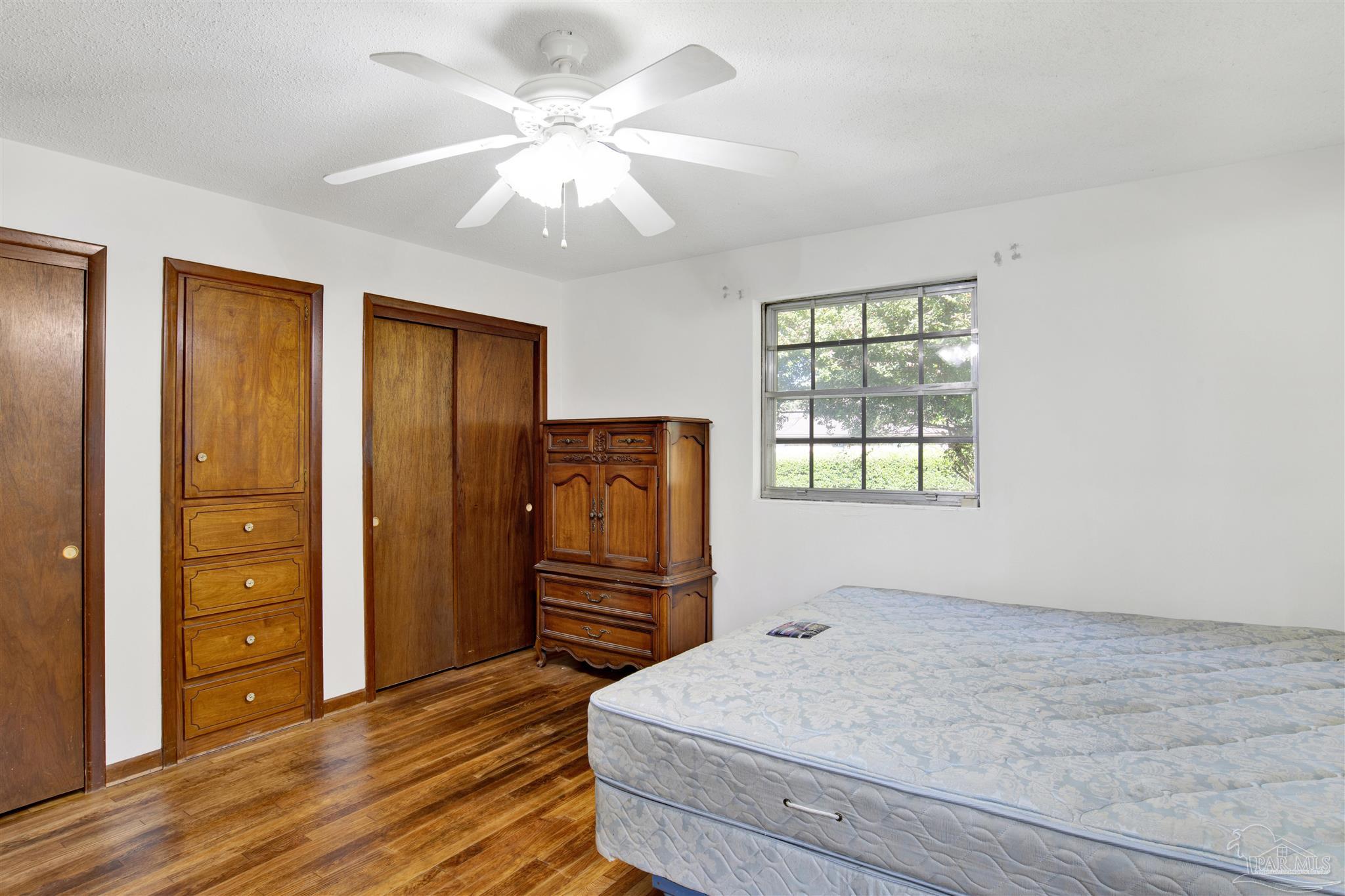 9621 Sidney Road Pensacola, FL 32507 - Photo 15 of 30 a bedroom with a bed and a dresser