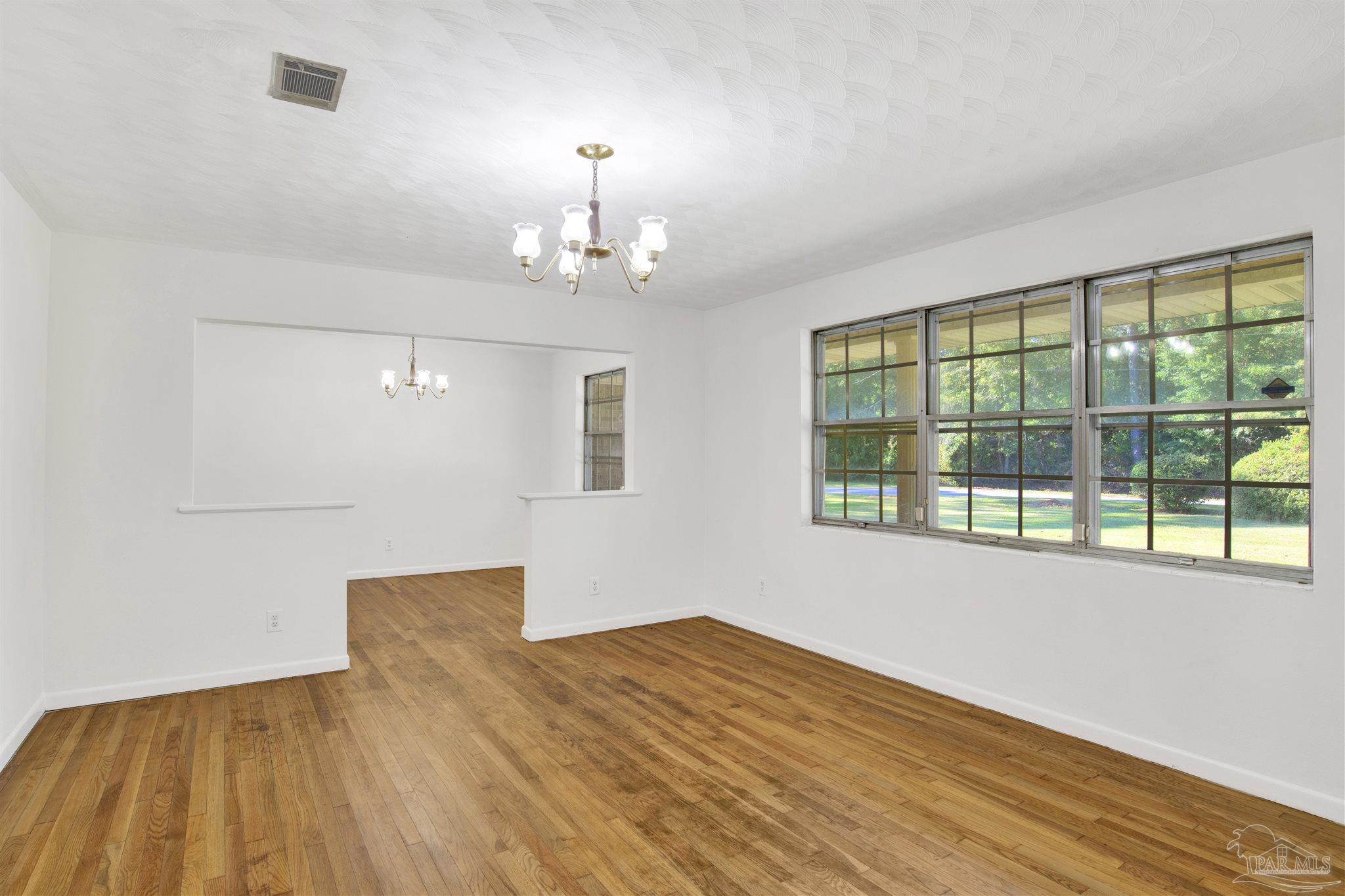 9621 Sidney Road Pensacola, FL 32507 - Photo 16 of 30 a view of empty room with wooden floor and fan