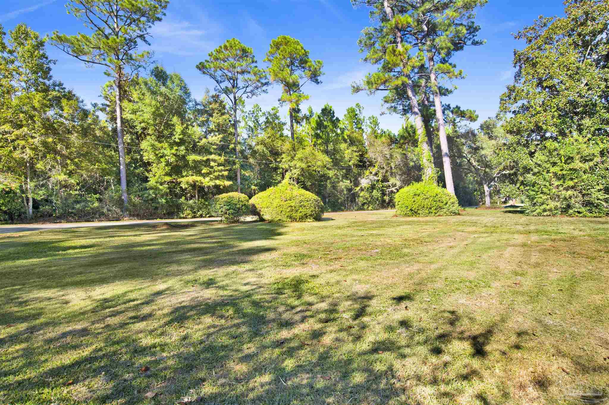 9621 Sidney Road Pensacola, FL 32507 - Photo 2 of 30 a view of swimming pool with a garden