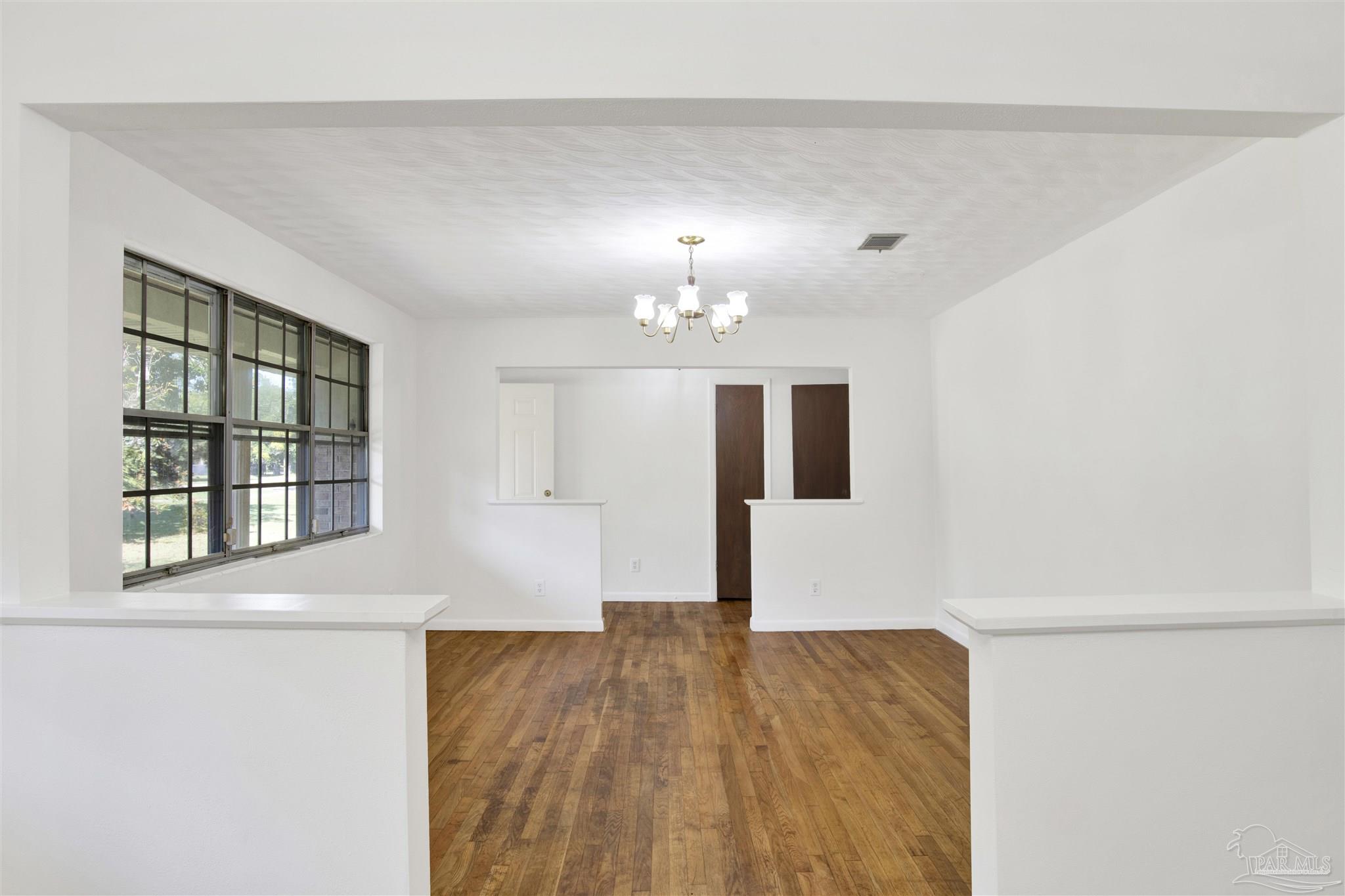 9621 Sidney Road Pensacola, FL 32507 - Photo 23 of 30 a view of empty room with wooden floor and window