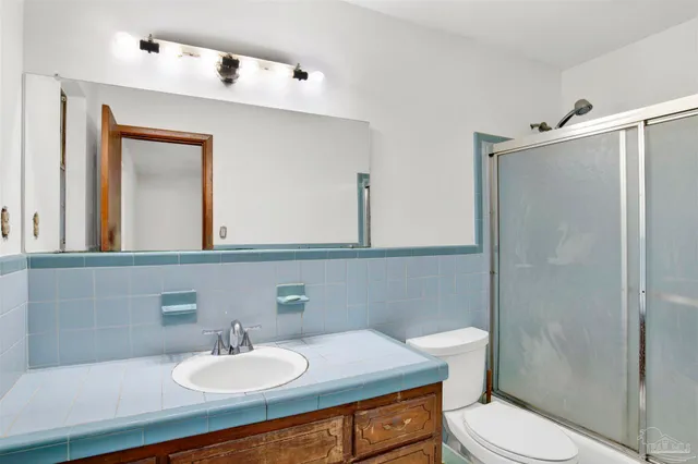 a bathroom with a sink toilet and mirror