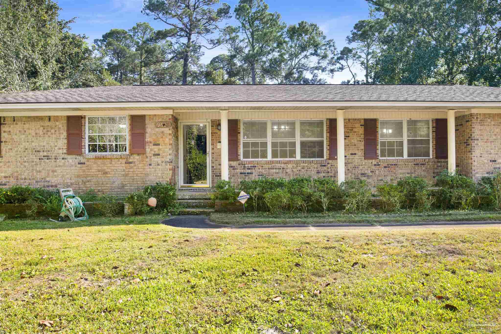 9621 Sidney Road Pensacola, FL 32507 - Photo 26 of 30 a front view of a house with garden