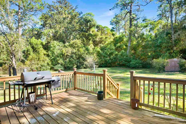 a view of a wooden deck with furniture