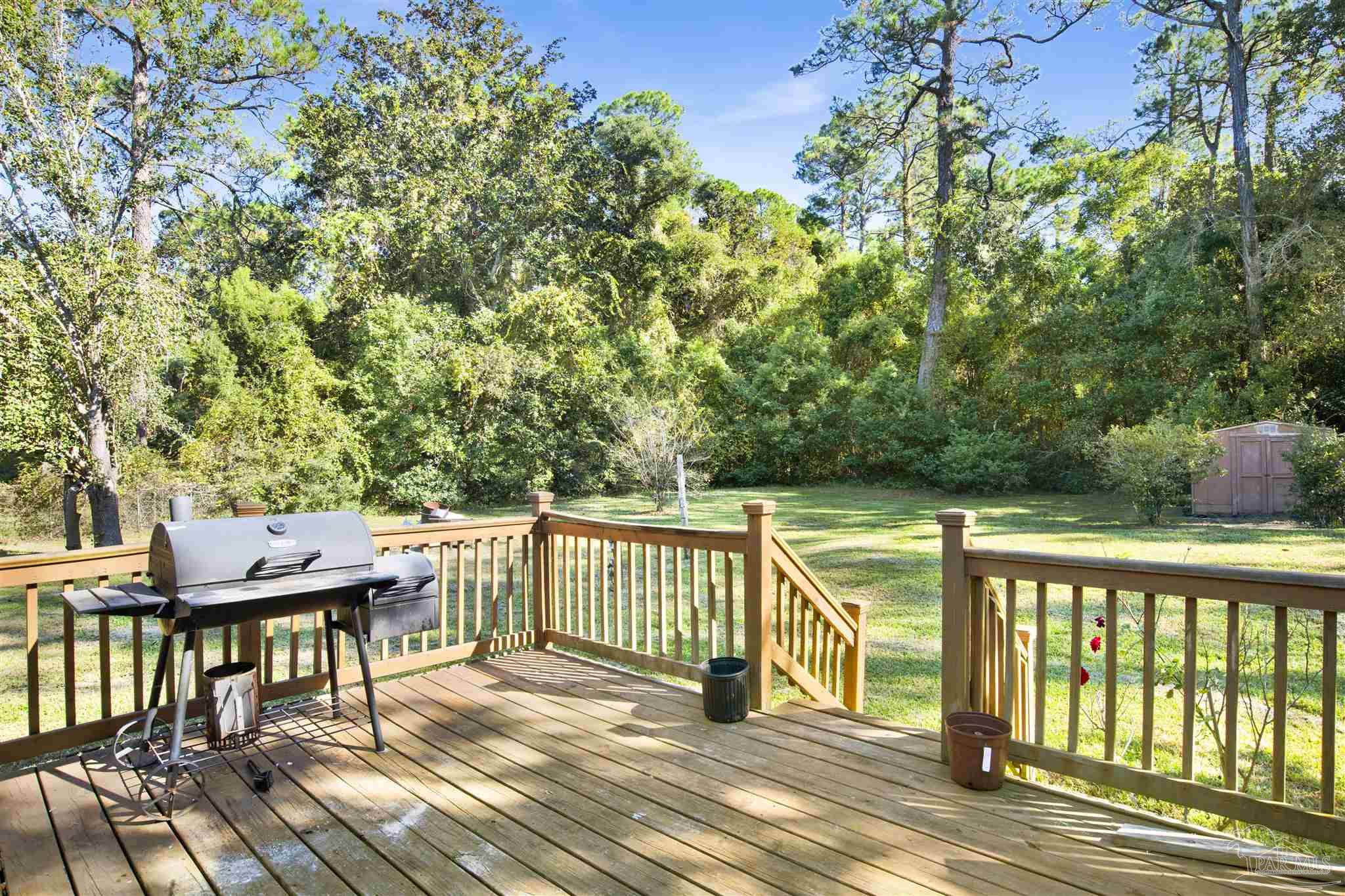 9621 Sidney Road Pensacola, FL 32507 - Photo 6 of 30 a view of a wooden deck with furniture