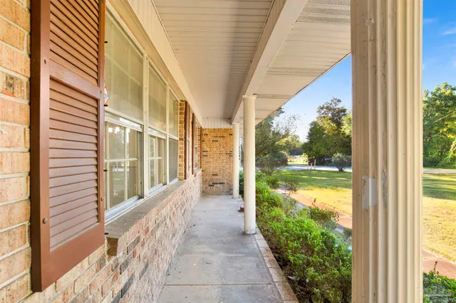 a view of a house with a yard and balcony