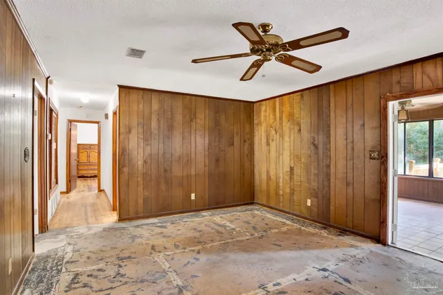 a view of an empty room with a ceiling fan