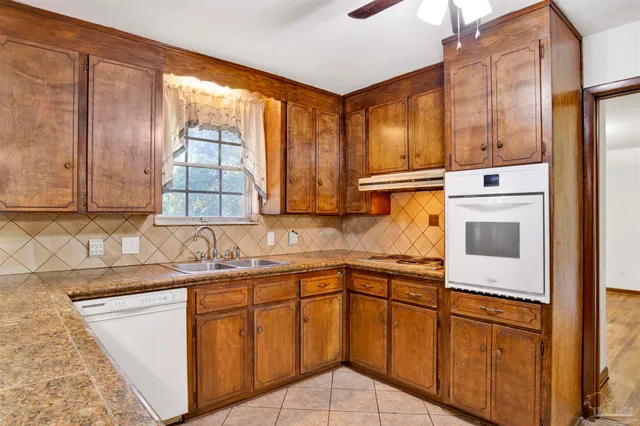 a kitchen with stainless steel appliances granite countertop a sink and a microwave