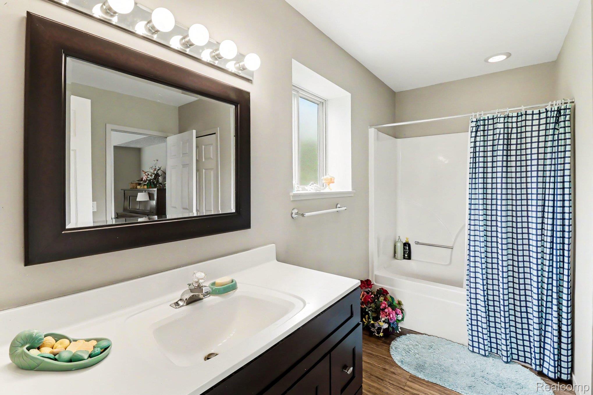 18501 Taylor Lake Road Holly, MI 48442 - Photo 24 of 35 New Bathroom featuring a dark wood-finish vanity, integrated sink, and white countertop