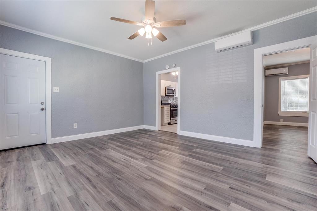 320 West Canty Street, Unit 2 Dallas, TX 75208 - Photo 1 of 11 a view of empty room with wooden floor and ceiling fan