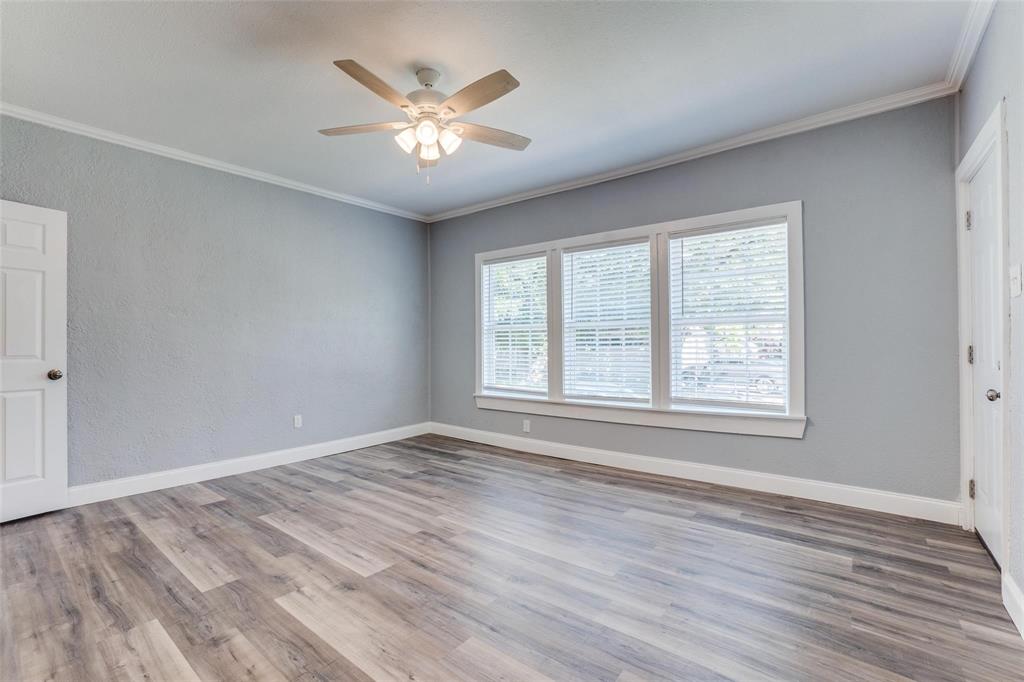 320 West Canty Street, Unit 2 Dallas, TX 75208 - Photo 2 of 11 a view of an empty room with a window and wooden floor